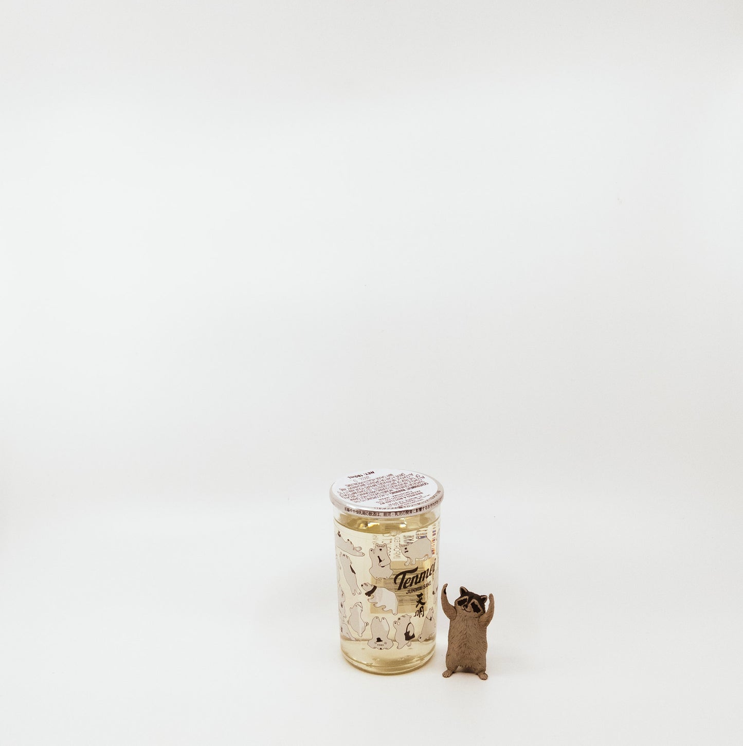 jar next to raccoon figurine