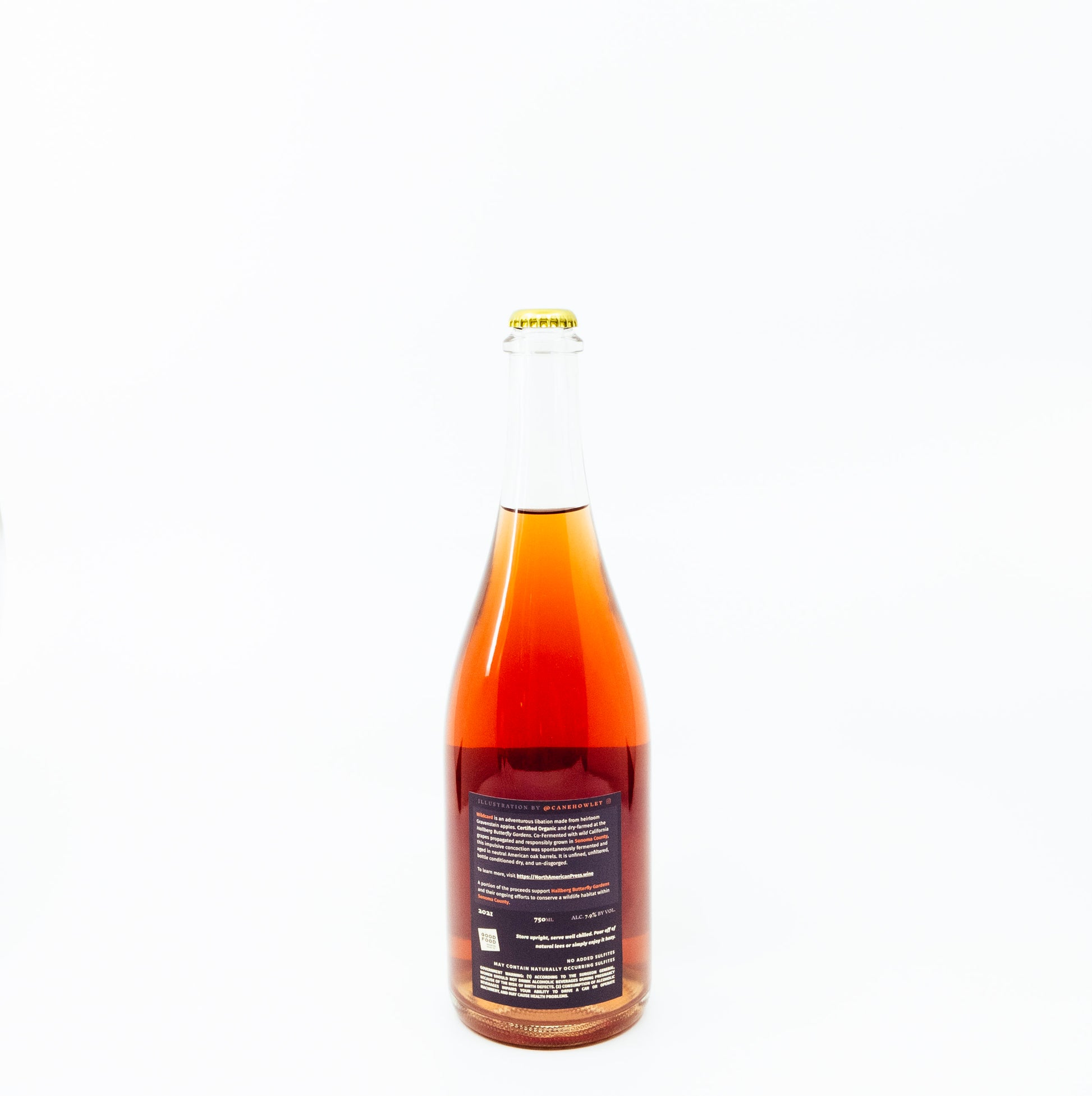 back of red glass bottle with moth on label
