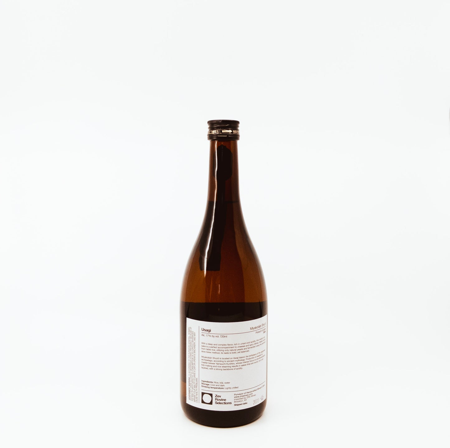 back of glass bottle with red feathers on label