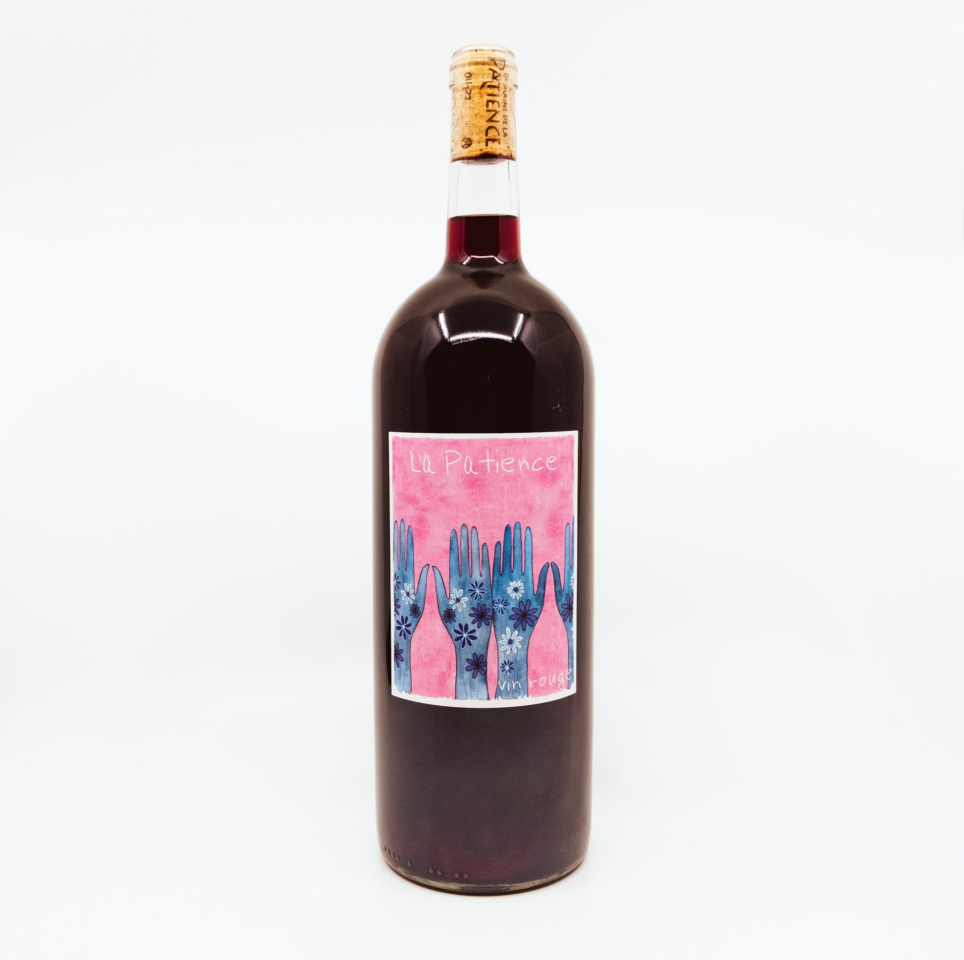 red wine bottle with blue hands on pink label