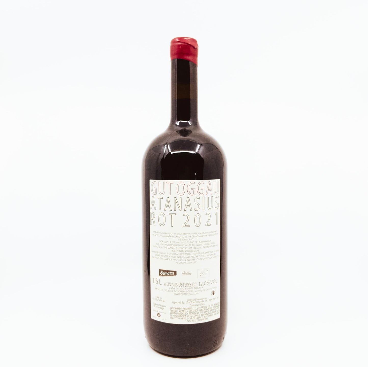 back of bottle with face on label and flower topper