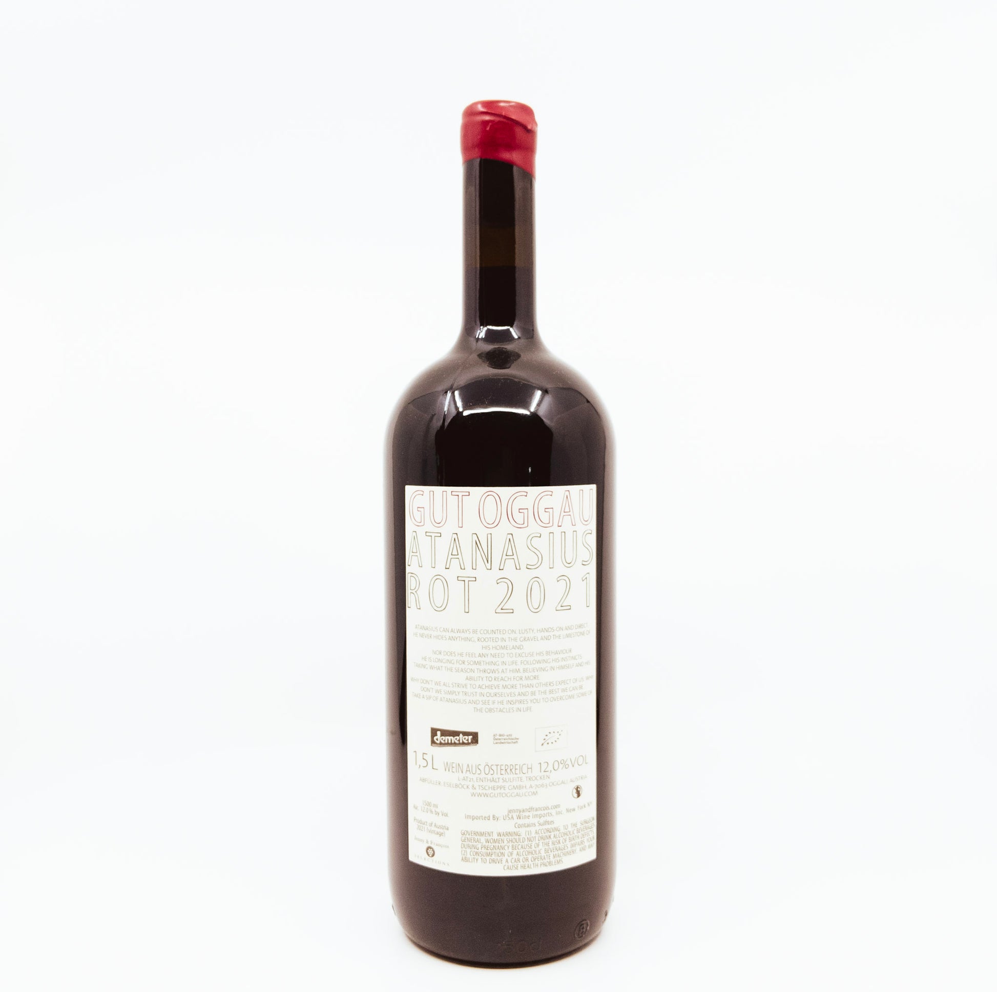 back of bottle with face on label and flower topper