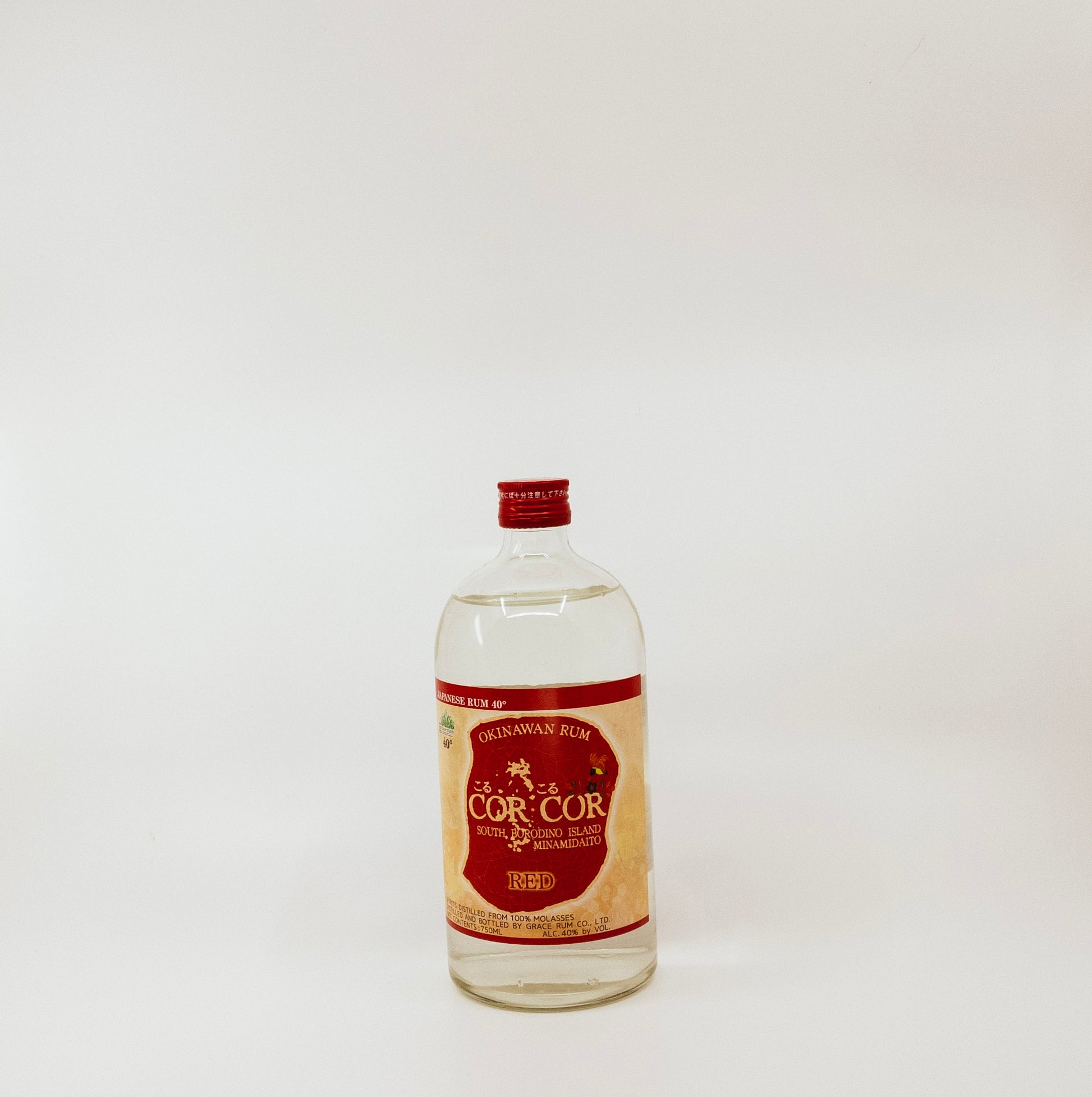 short glass bottle with red cap and label