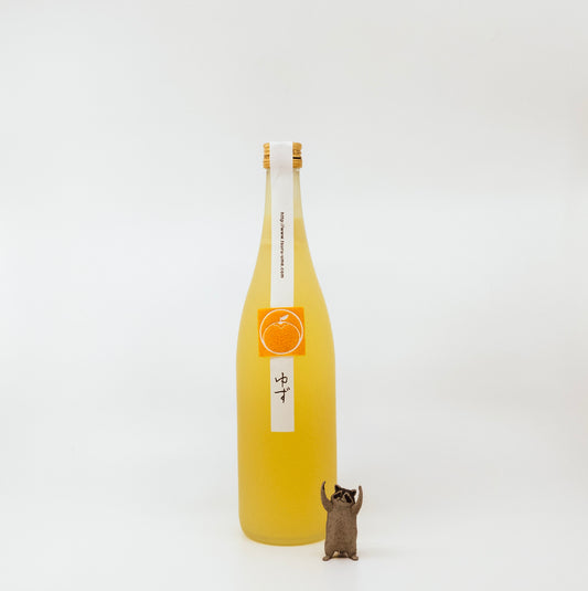 yellow bottle with raccoon figurine