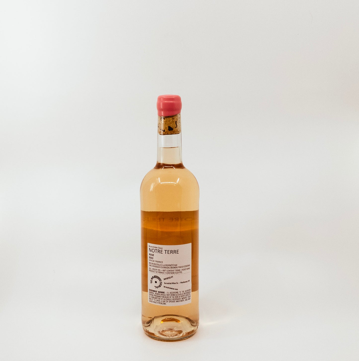 back of wine bottle with pink topper and yellow on white label