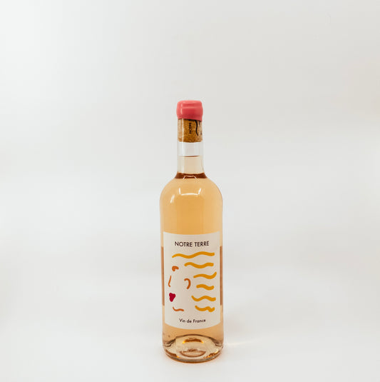 wine bottle with pink topper and yellow on white label