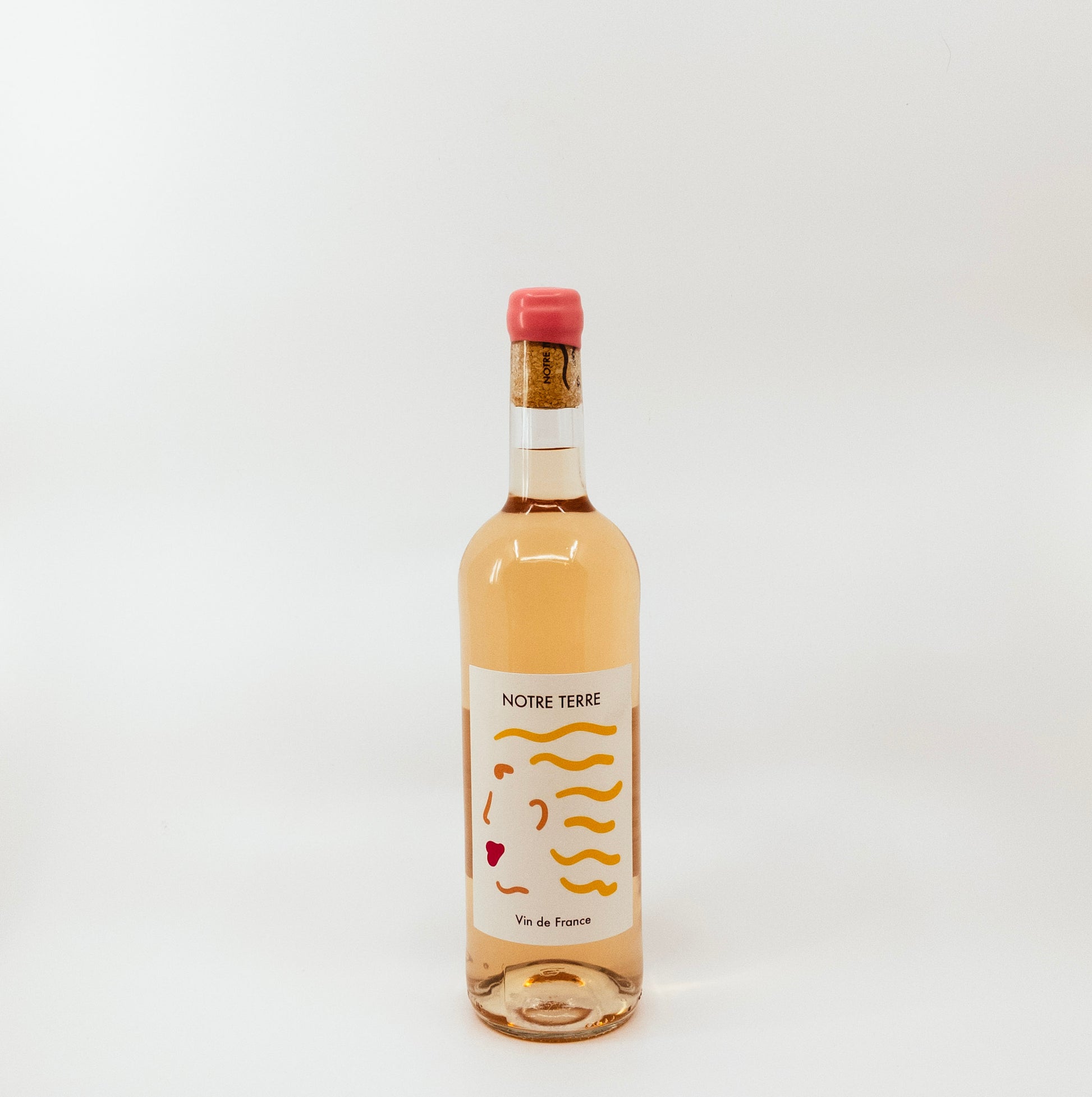 wine bottle with pink topper and yellow on white label