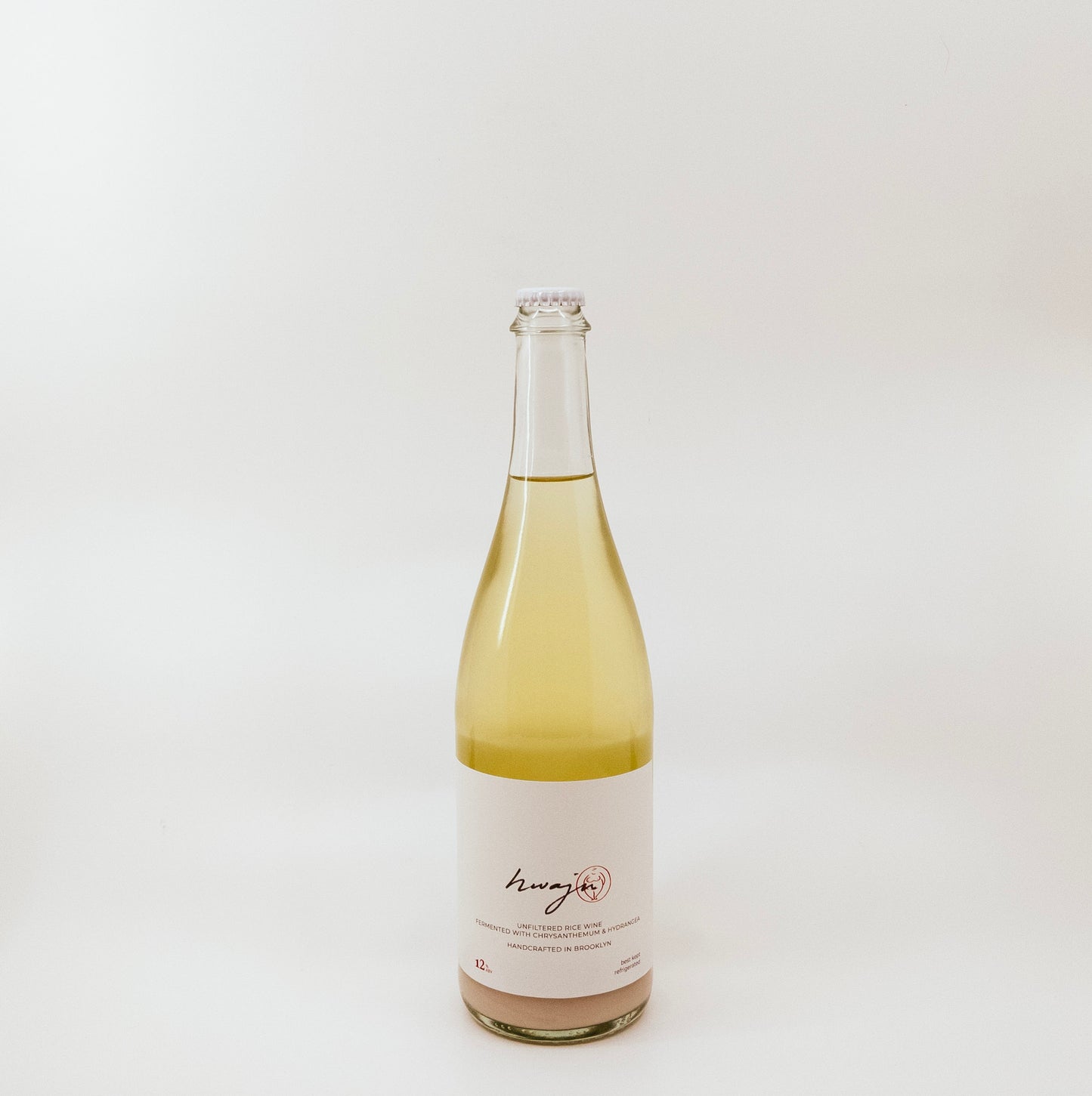 light yellow glass bottle with white label