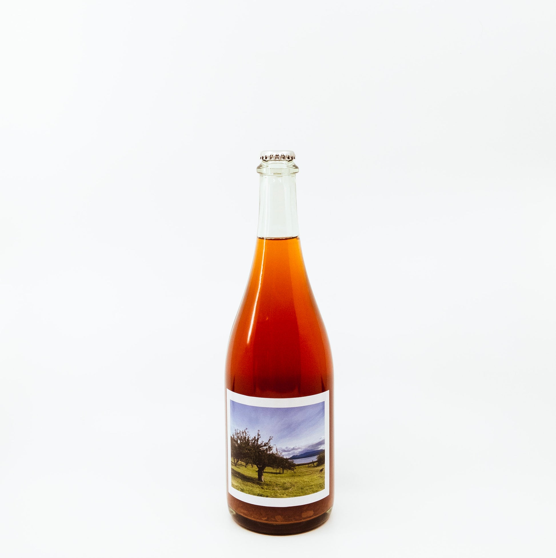 red glass bottle with scenic label