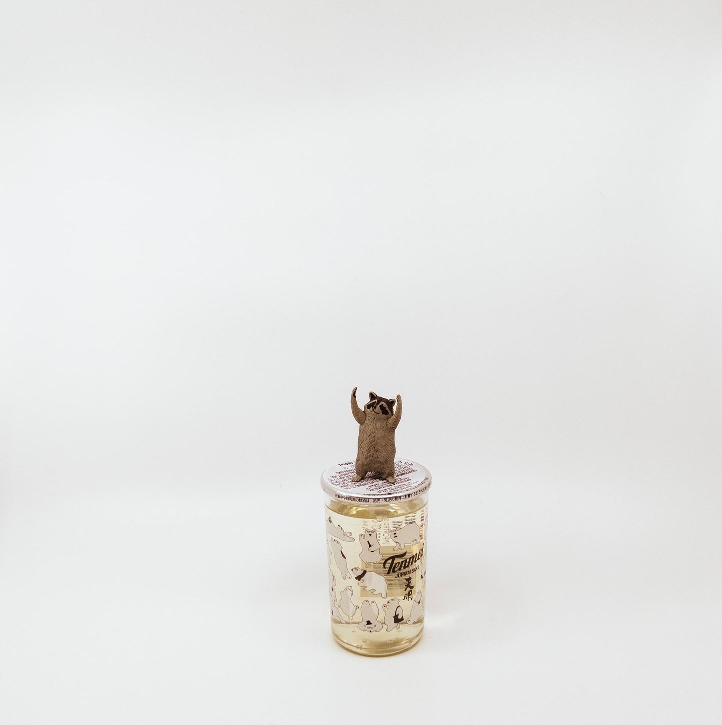 jar with raccoon figurine on top
