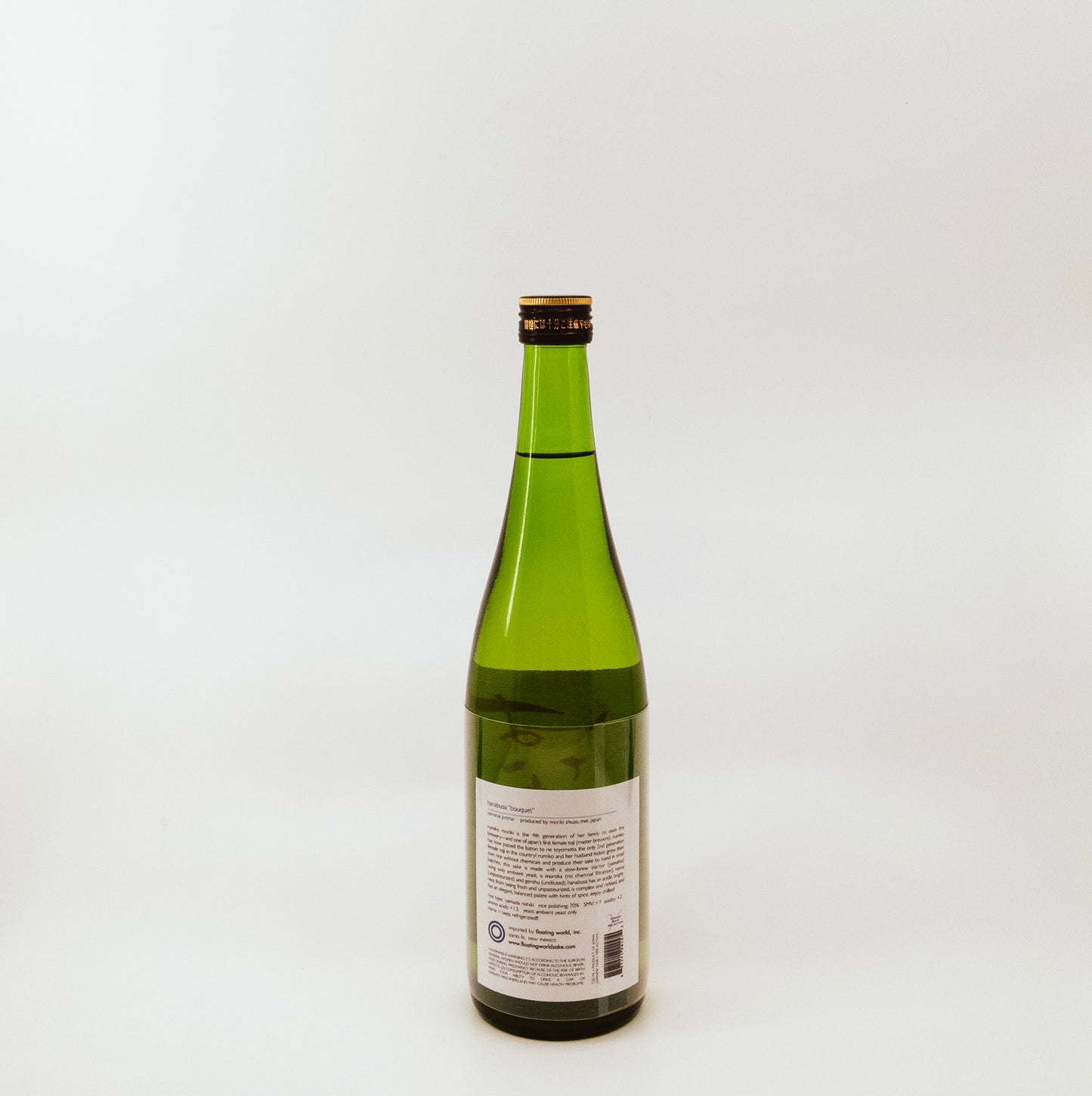 back of green glass bottle with red writing on cream label