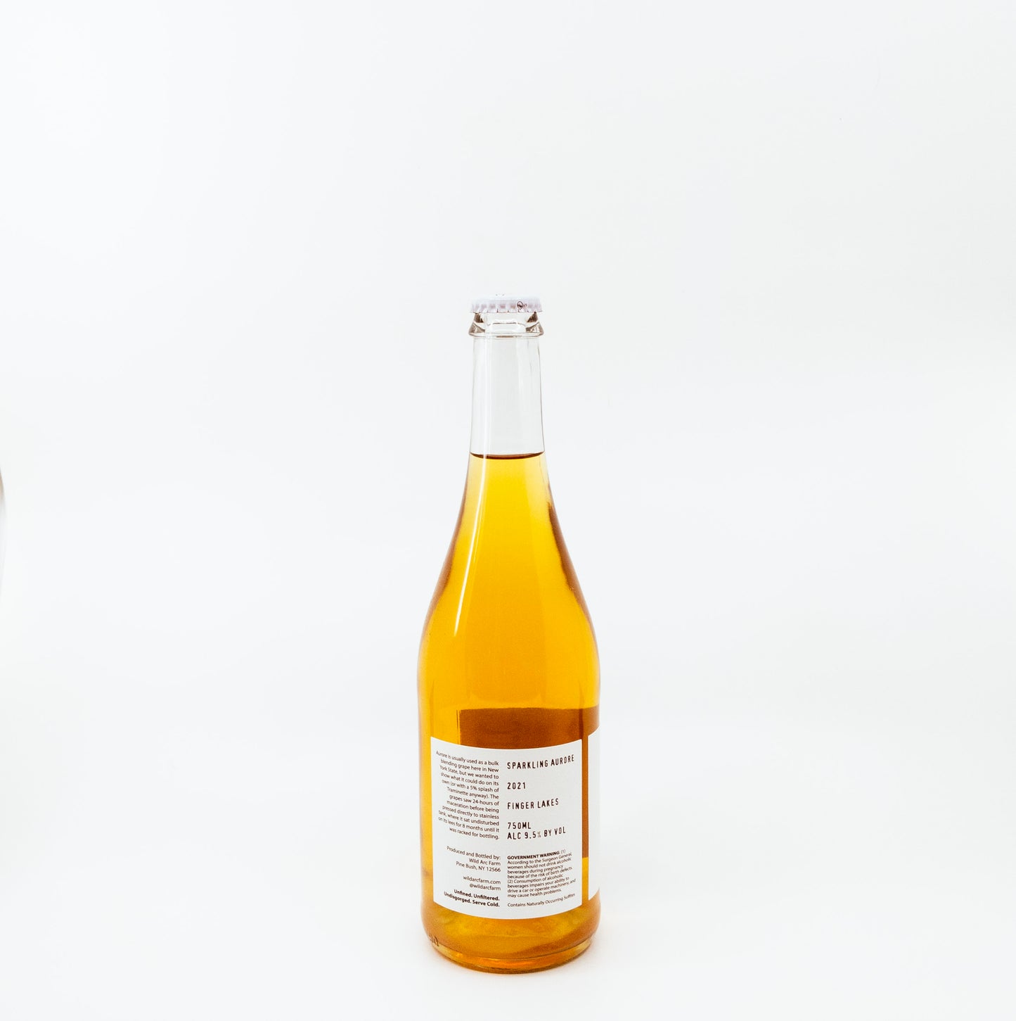 back of yellow glass bottle with dark circle on white label
