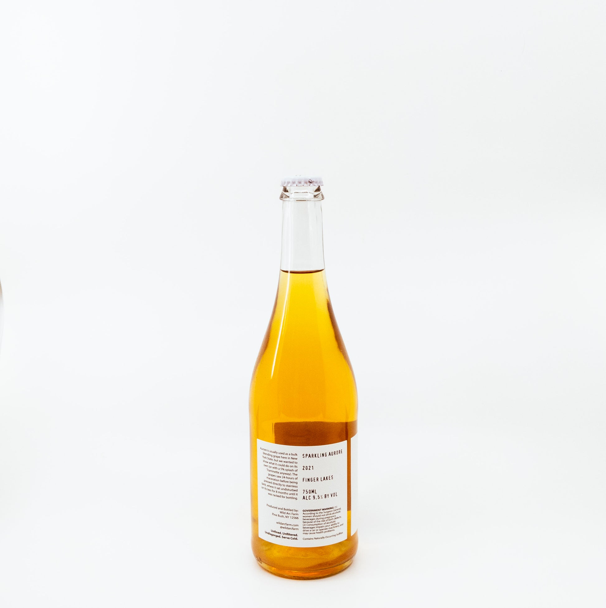 back of yellow glass bottle with dark circle on white label