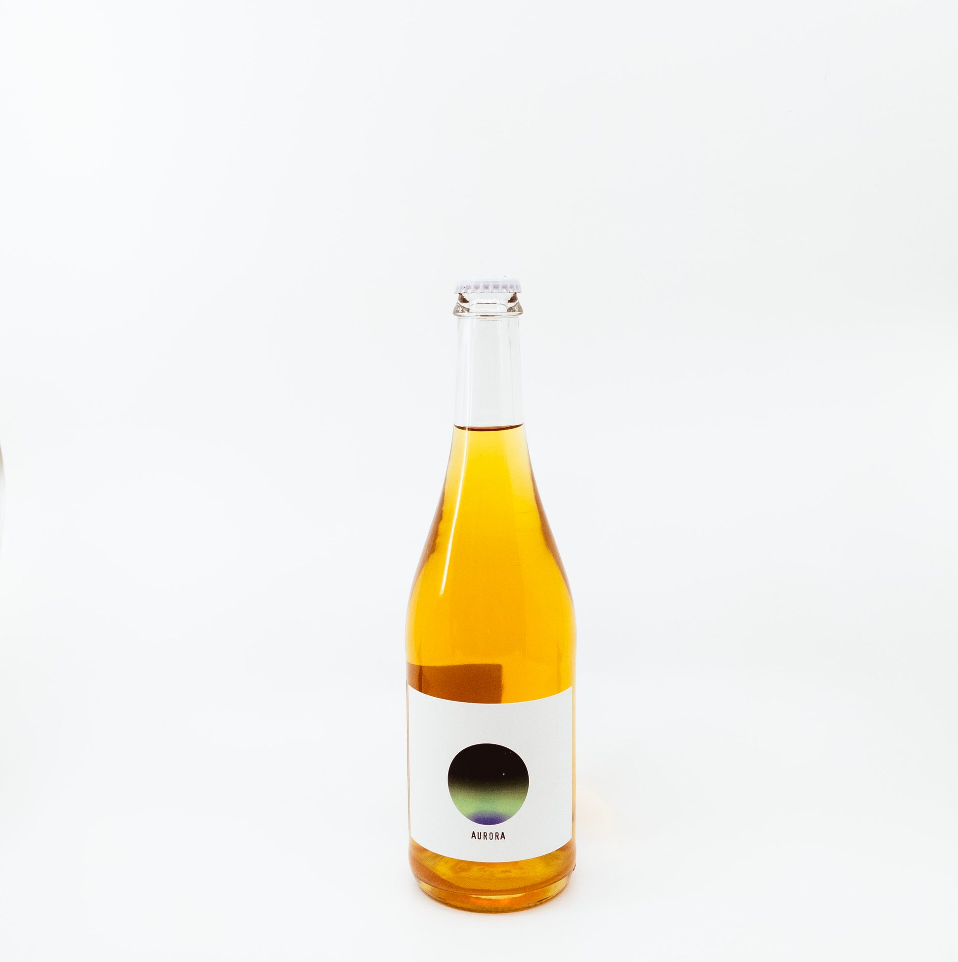 yellow glass bottle with dark circle on white label