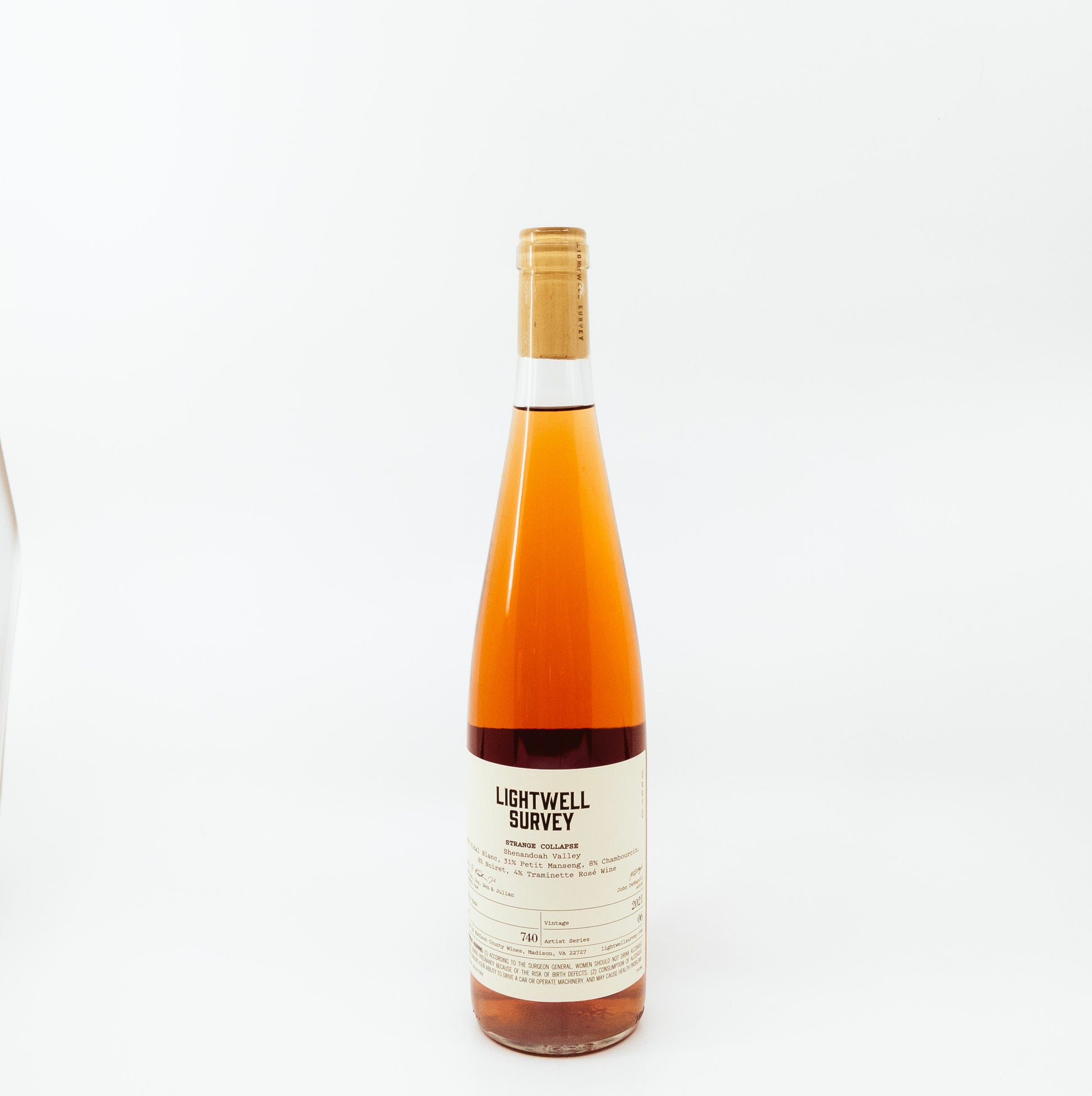 back of orange glass bottle with flames on label