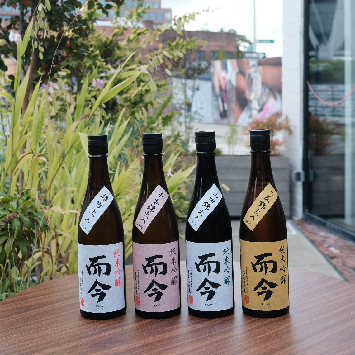 four bottles on wooden table