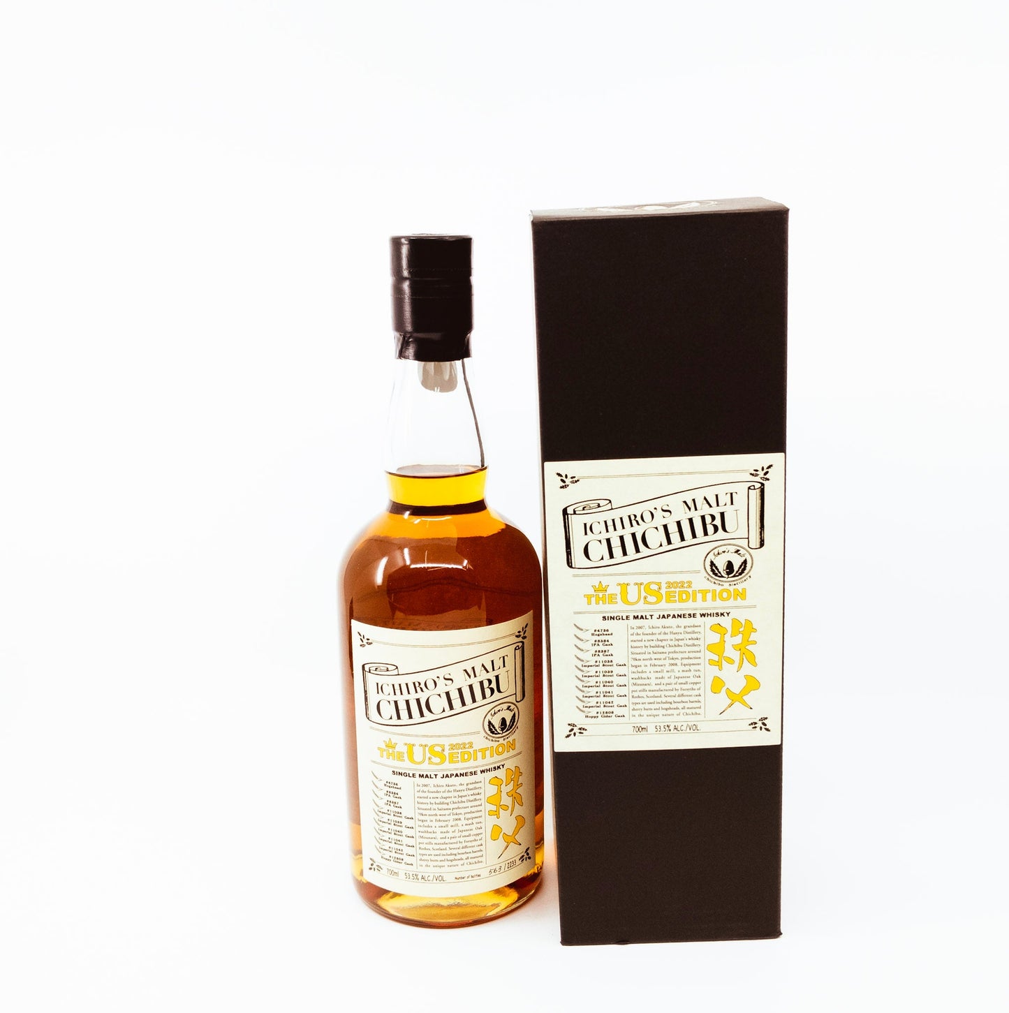 small bottle of whisky next to box