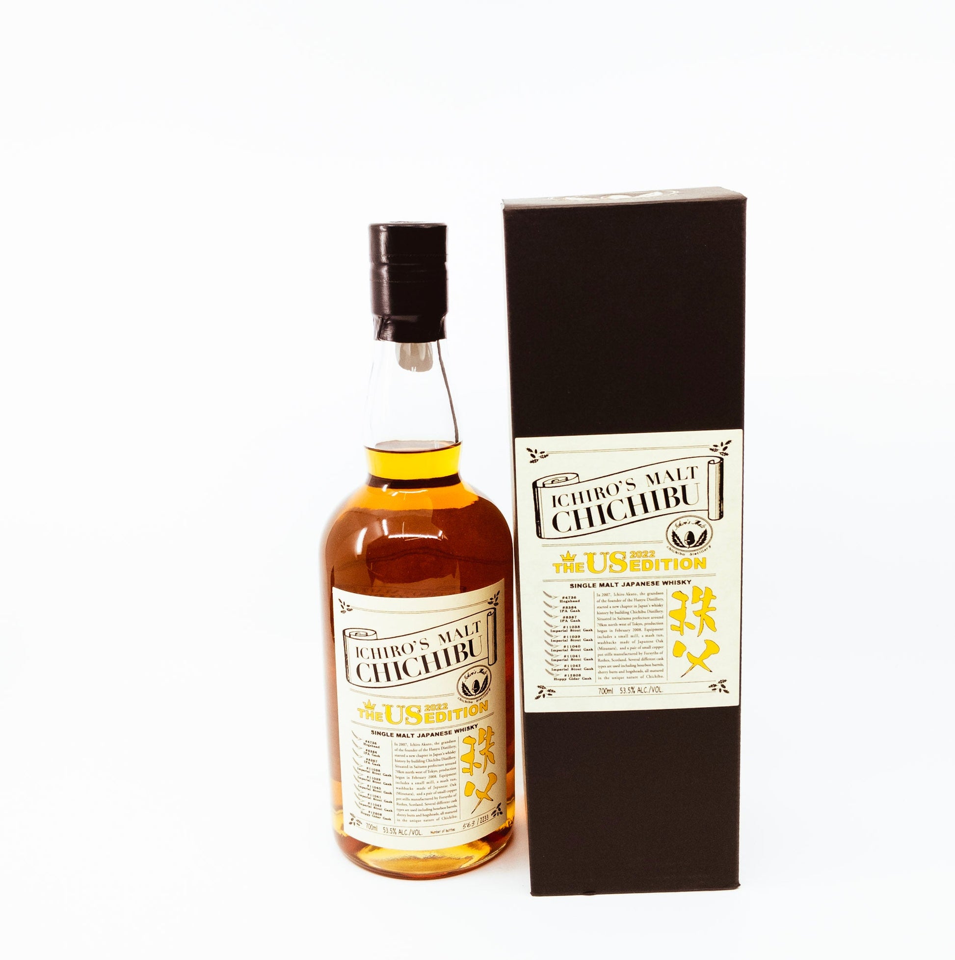 small bottle of whisky next to box