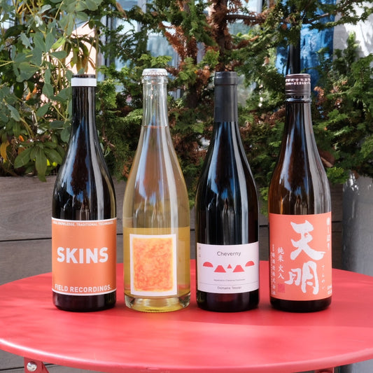 four bottles of wine on red table