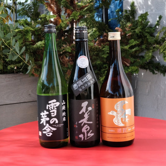 three bottles of wine on red table