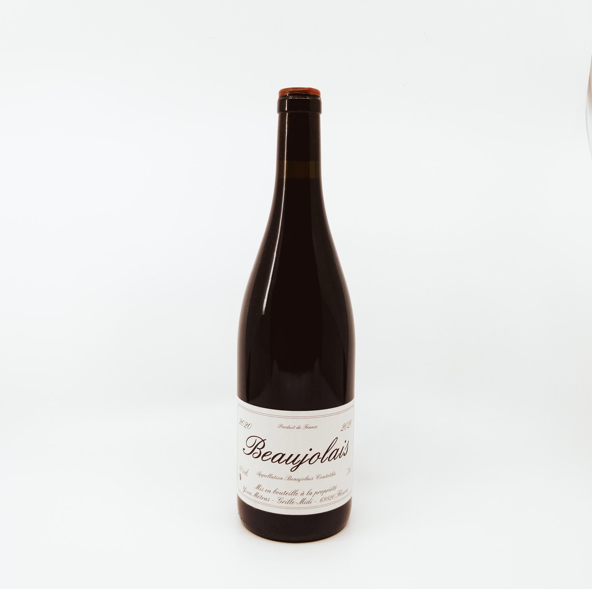 dark bottle with cursive writing on label