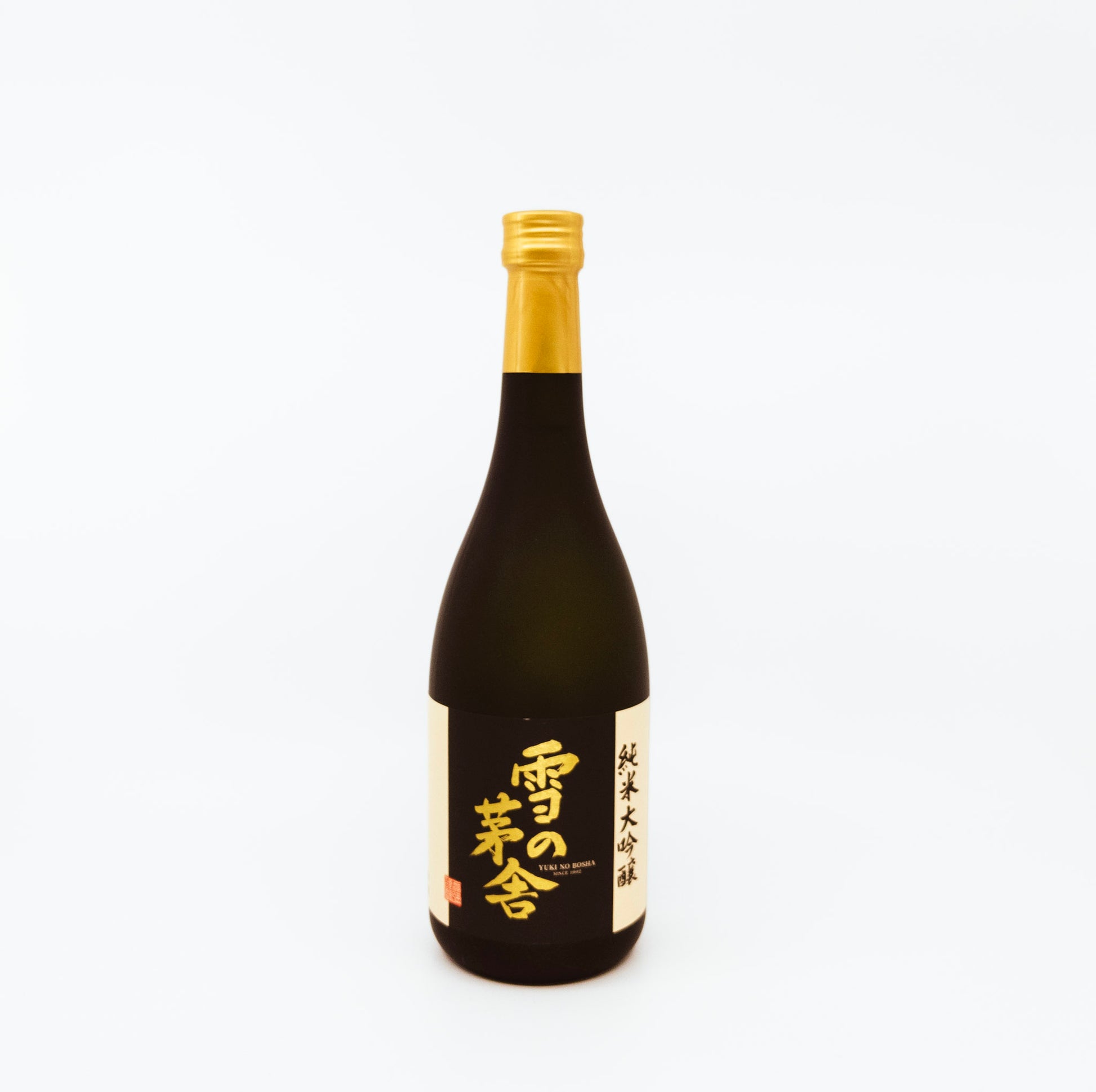 black bottle with gold writing on black label and gold topper