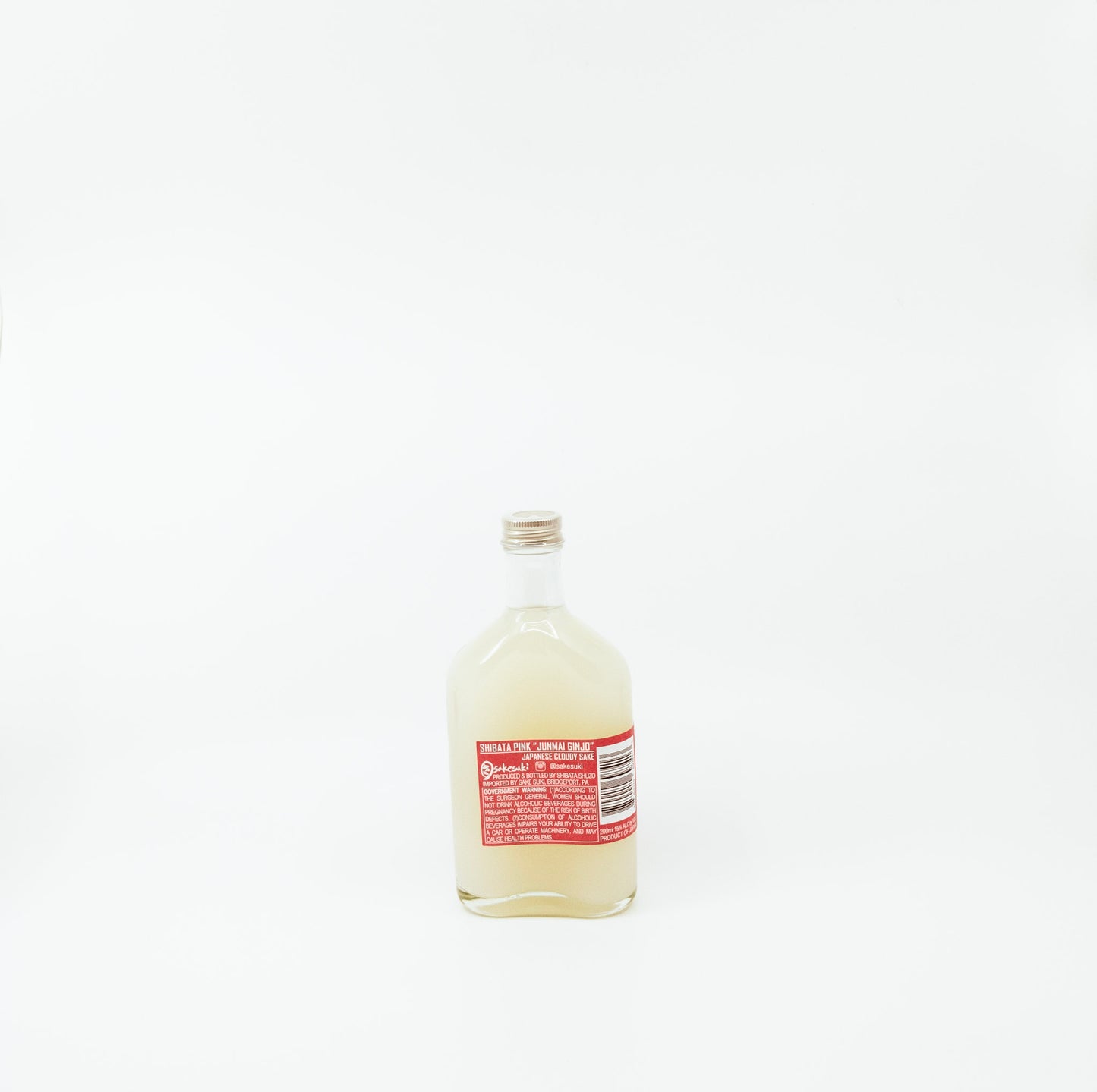 back of short glass bottle with coral label