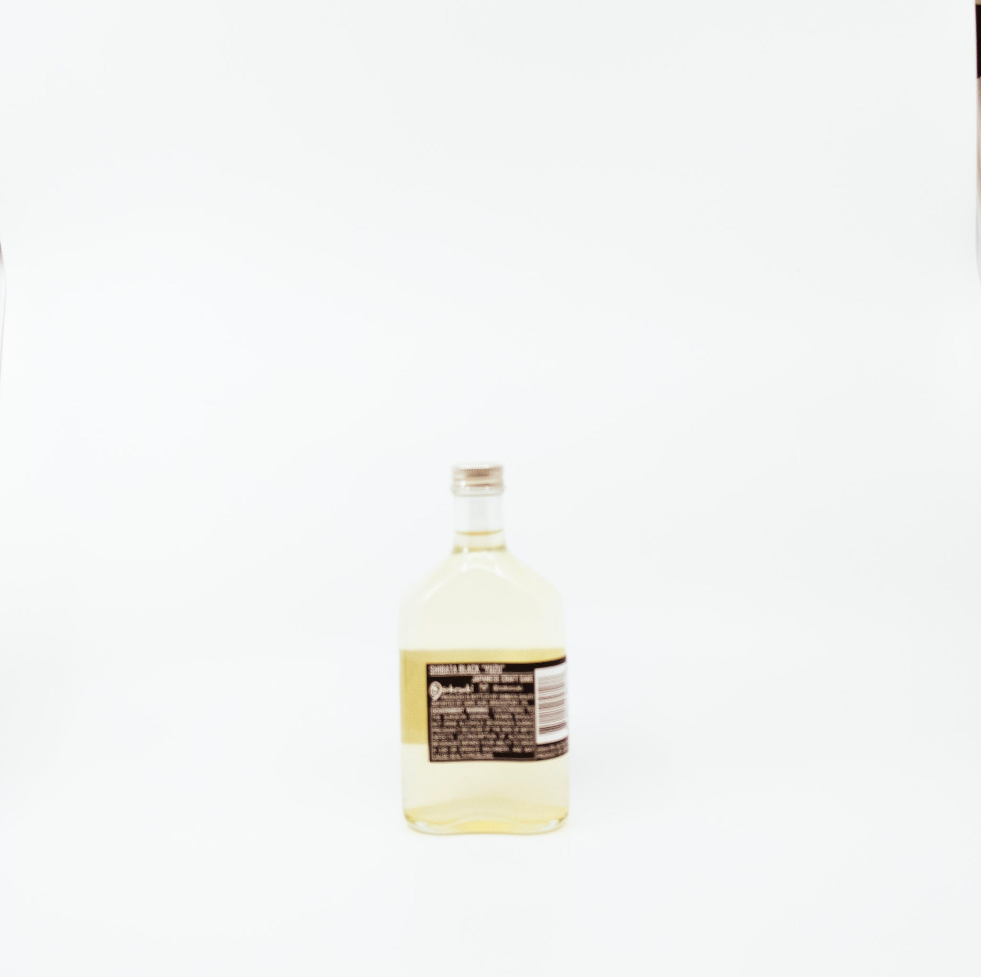 back of short glass bottle with black label