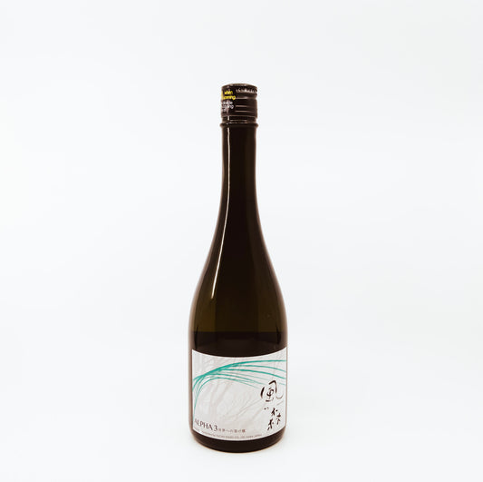 black bottle with teal leaves on white label