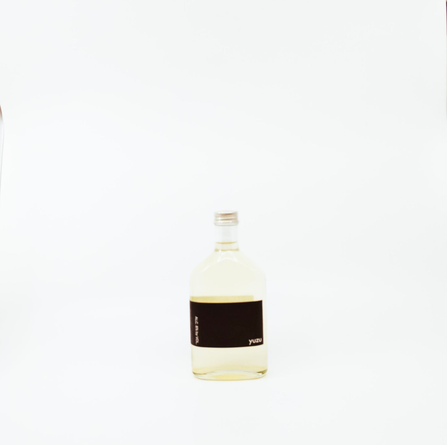 short glass bottle with black label