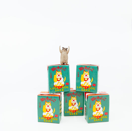 five boxes of lucky dog sake with raccoon figurine on top