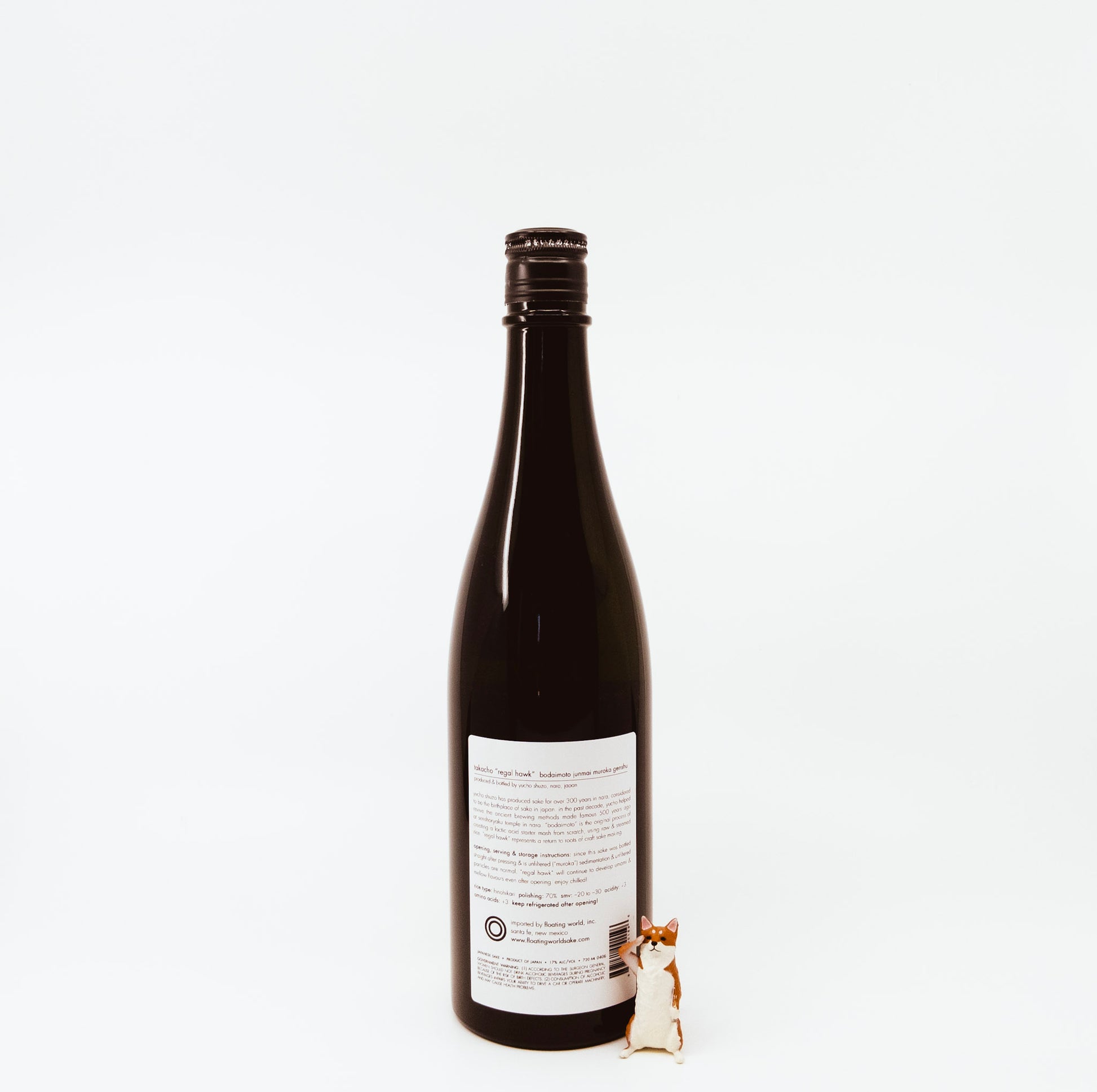 back of bottle next to fox figurine