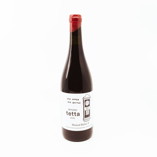 black bottle of tetta with red topper