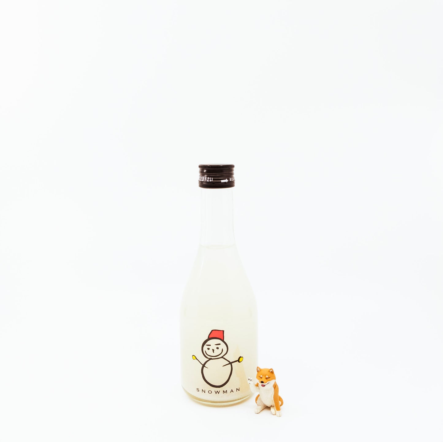 small bottle of snowman next to dog figurine