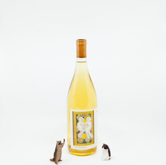 wine bottle next to raccoon and cat figurines
