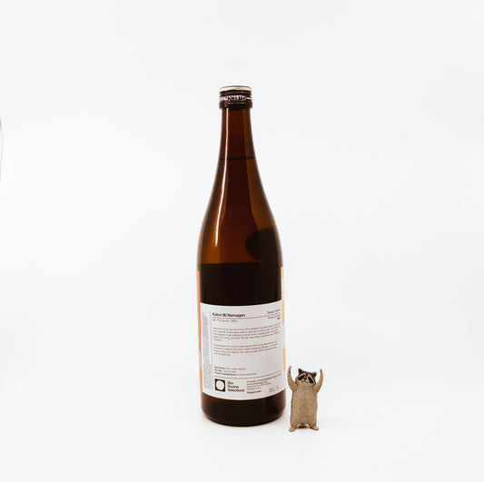 back of bottle next to raccoon figurine