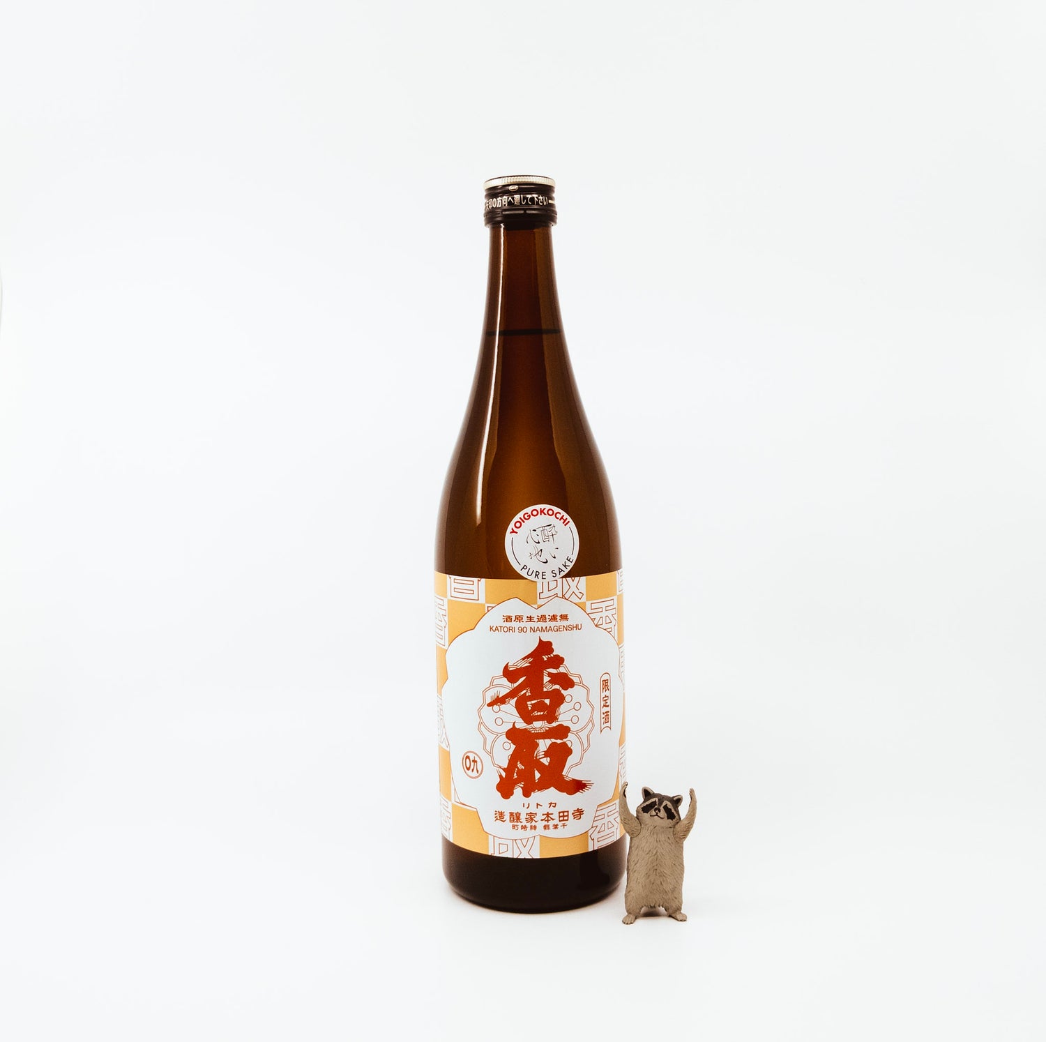 bottle next to raccoon figurine
