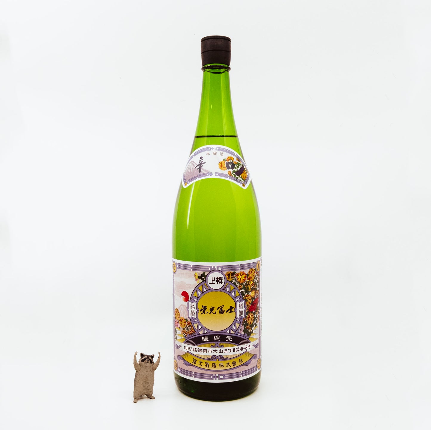 green bottle next to raccoon figurine
