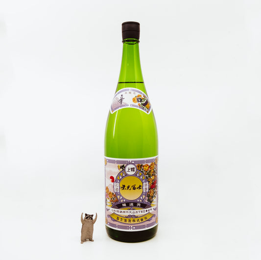 green bottle next to raccoon figurine