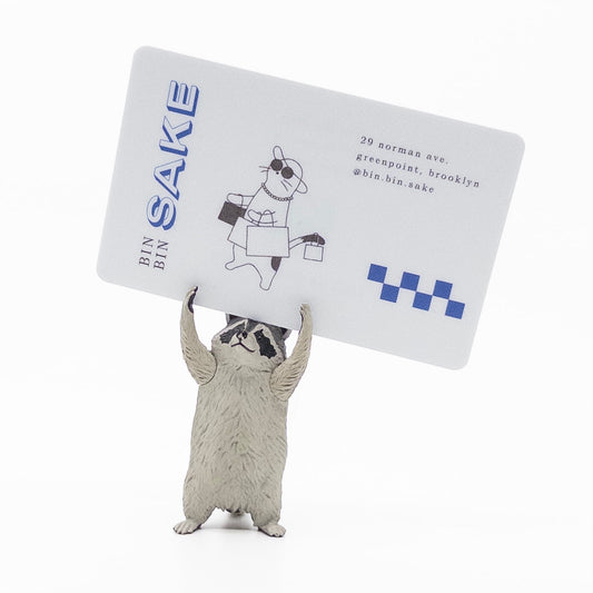 raccoon figurine holding bin bin sake card