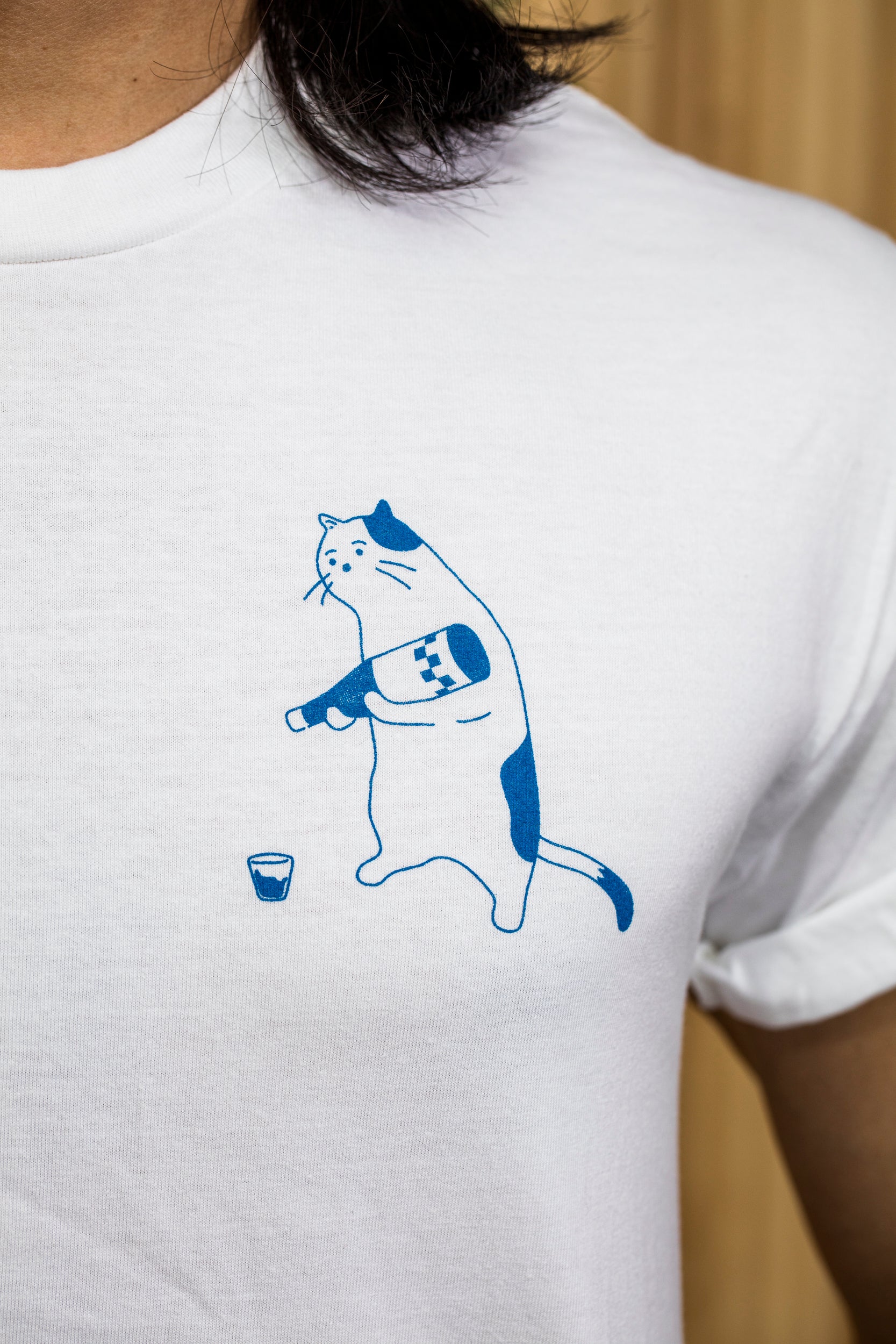white t shirt with blue outline of cat pouring wine in glass