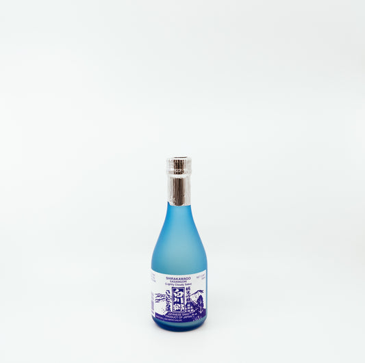 short blue bottle with dark blue graphic on white label