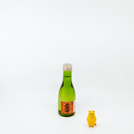 small green bottle near cat figurine